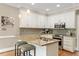Modern kitchen with granite counters, stainless steel appliances, and white cabinetry at 105 Fifemoor Ct, Cary, NC 27518