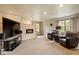 Carpeted living room featuring a stone accent wall with a fireplace and mounted television at 105 Fifemoor Ct, Cary, NC 27518