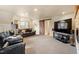 Spacious living room boasts plush carpeting, recessed lighting, and a mounted television at 105 Fifemoor Ct, Cary, NC 27518