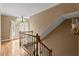 Staircase landing featuring hardwood floors, natural light, and views of the neighborhood at 105 Fifemoor Ct, Cary, NC 27518