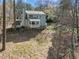Backyard showing the house, shed and wooded area at 109 Boulder Ln, Chapel Hill, NC 27514