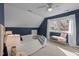 Attic bedroom with angled walls, dormer window, and cozy bench seating at 109 Boulder Ln, Chapel Hill, NC 27514
