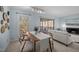 Dining area with a table, fur covered chairs, adjacent to the living room and natural light at 109 Boulder Ln, Chapel Hill, NC 27514