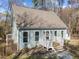 Charming light blue home with a gabled roof, front porch and fenced in yard at 109 Boulder Ln, Chapel Hill, NC 27514