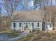 Charming light blue home with a gabled roof, front porch and well maintained yard at 109 Boulder Ln, Chapel Hill, NC 27514