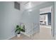 Upstairs hallway with white railings and an open doorway to a bedroom at 109 Boulder Ln, Chapel Hill, NC 27514
