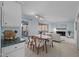 Open-concept living and dining area featuring a cozy fireplace and sliding glass doors to the outside at 109 Boulder Ln, Chapel Hill, NC 27514