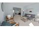 Comfortable living room with blue walls, carpeted floors, modern furniture, and decorative touches at 109 Boulder Ln, Chapel Hill, NC 27514