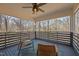 Enclosed patio with a view of the forest. There are two rattan chairs sitting on a geometric teal rug at 109 Boulder Ln, Chapel Hill, NC 27514
