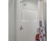The shower is enclosed in white fiberglass and has a glass handle and a curtain with a floral pattern at 109 Boulder Ln, Chapel Hill, NC 27514