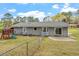Fenced backyard with ample lawn space, mature trees, patio, and a small play structure at 1107 Edgebrook Dr, Garner, NC 27529