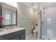 Clean bathroom featuring a glass door shower, vanity, and decorative mirror at 1107 Edgebrook Dr, Garner, NC 27529