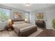 Comfortable staged bedroom with a wooden bed frame, soft rug, neutral walls, and two windows at 1107 Edgebrook Dr, Garner, NC 27529
