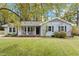 Charming single-story home with a covered front porch and well-maintained landscaping in a serene, wooded setting at 1107 Edgebrook Dr, Garner, NC 27529