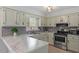 Well-lit kitchen with modern appliances, stone countertops, and stylish subway tile backsplash at 1107 Edgebrook Dr, Garner, NC 27529