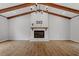 Bright living room with exposed beams and a cozy fireplace, creating a warm and inviting atmosphere at 1107 Edgebrook Dr, Garner, NC 27529