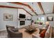 Staged living room with a brick fireplace, exposed beams, and stylish decor at 1107 Edgebrook Dr, Garner, NC 27529