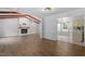 Living room blending seamlessly into the kitchen, featuring wood floors and modern lighting at 1107 Edgebrook Dr, Garner, NC 27529
