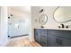 Bathroom featuring a double vanity with dark cabinets, white quartz counters, and a glass shower with black trim at 120 Sequoia Dr, Louisburg, NC 27549