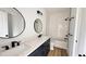 Bathroom with double vanity, black fixtures, and subway tiled shower-tub at 120 Sequoia Dr, Louisburg, NC 27549