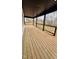 Spacious wooden deck with black trim offers great outdoor living space with a view of trees at 120 Sequoia Dr, Louisburg, NC 27549
