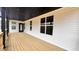 Wide-angle of outdoor wooden deck with black trim and covered ceiling with white exterior at 120 Sequoia Dr, Louisburg, NC 27549