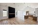 Open-concept living room with vaulted ceilings, fireplace, and wood floors at 120 Sequoia Dr, Louisburg, NC 27549