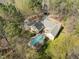 Stunning aerial view of a large home with a private pool and landscaped grounds surrounded by trees at 120 Teasel Ct, Clayton, NC 27527