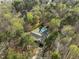 Aerial view showcasing a home nestled among mature trees and landscaping with a backyard pool at 120 Teasel Ct, Clayton, NC 27527