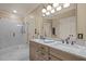 Bathroom featuring a double vanity with marble countertops, shower, and framed mirror at 120 Teasel Ct, Clayton, NC 27527
