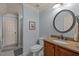 Bathroom with blue walls featuring a dark wood vanity and framed mirror at 120 Teasel Ct, Clayton, NC 27527