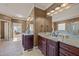Another bathroom view showing the double sink vanity and a partial view of the bathtub and shower at 120 Teasel Ct, Clayton, NC 27527