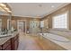 Elegant bathroom featuring double vanity, frameless shower, and soaking tub at 120 Teasel Ct, Clayton, NC 27527