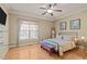 Bright bedroom with hardwood floors, crown molding, and neutral colored walls at 120 Teasel Ct, Clayton, NC 27527