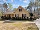 Single-story home featuring a covered front porch, manicured landscaping and a side-entry carport at 120 Teasel Ct, Clayton, NC 27527