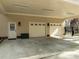 Three-car garage featuring carriage doors, ample lighting and convenient side entry at 120 Teasel Ct, Clayton, NC 27527