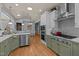 Modern kitchen featuring stylish cabinets, granite countertops, stainless steel appliances, and hardwood floors at 120 Teasel Ct, Clayton, NC 27527