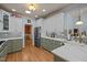 A spacious kitchen showcasing a stylish backsplash, hardwood floors, and two-tone cabinetry at 120 Teasel Ct, Clayton, NC 27527