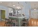Kitchen featuring a breakfast bar with seating, stainless steel appliances, and light blue accents at 120 Teasel Ct, Clayton, NC 27527