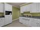 Kitchen featuring white cabinetry, dark countertops, and tiled flooring at 120 Teasel Ct, Clayton, NC 27527