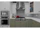 This kitchen boasts a stainless steel vent hood, herringbone backsplash, and two-tone cabinetry at 120 Teasel Ct, Clayton, NC 27527