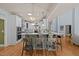 Bright, open-concept kitchen featuring a large center island with barstool seating and modern appliances at 120 Teasel Ct, Clayton, NC 27527