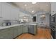 Well-appointed kitchen with custom cabinets, stainless steel appliances, and an open layout to the dining area at 120 Teasel Ct, Clayton, NC 27527