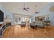 Bright and airy living room with hardwood floors, a fireplace, large windows, and vaulted ceilings at 120 Teasel Ct, Clayton, NC 27527
