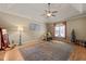 Spacious living room with tray ceiling, hardwood floors, and a ceiling fan at 120 Teasel Ct, Clayton, NC 27527