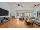 Cozy living room featuring a fireplace, large windows, hardwood floors, and comfortable seating at 120 Teasel Ct, Clayton, NC 27527