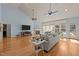 Open living room with vaulted ceilings, fireplace, large windows, and hardwood floors throughout at 120 Teasel Ct, Clayton, NC 27527