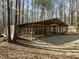 Enclosed outbuilding providing secure storage and protection from the elements, with exterior fencing at 120 Teasel Ct, Clayton, NC 27527
