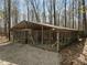 Secure and durable outbuilding, ideal for storage or hobby space, with gravel surrounding at 120 Teasel Ct, Clayton, NC 27527