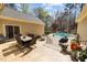 Back patio with wrought iron table and chairs overlooking inground pool at 120 Teasel Ct, Clayton, NC 27527
